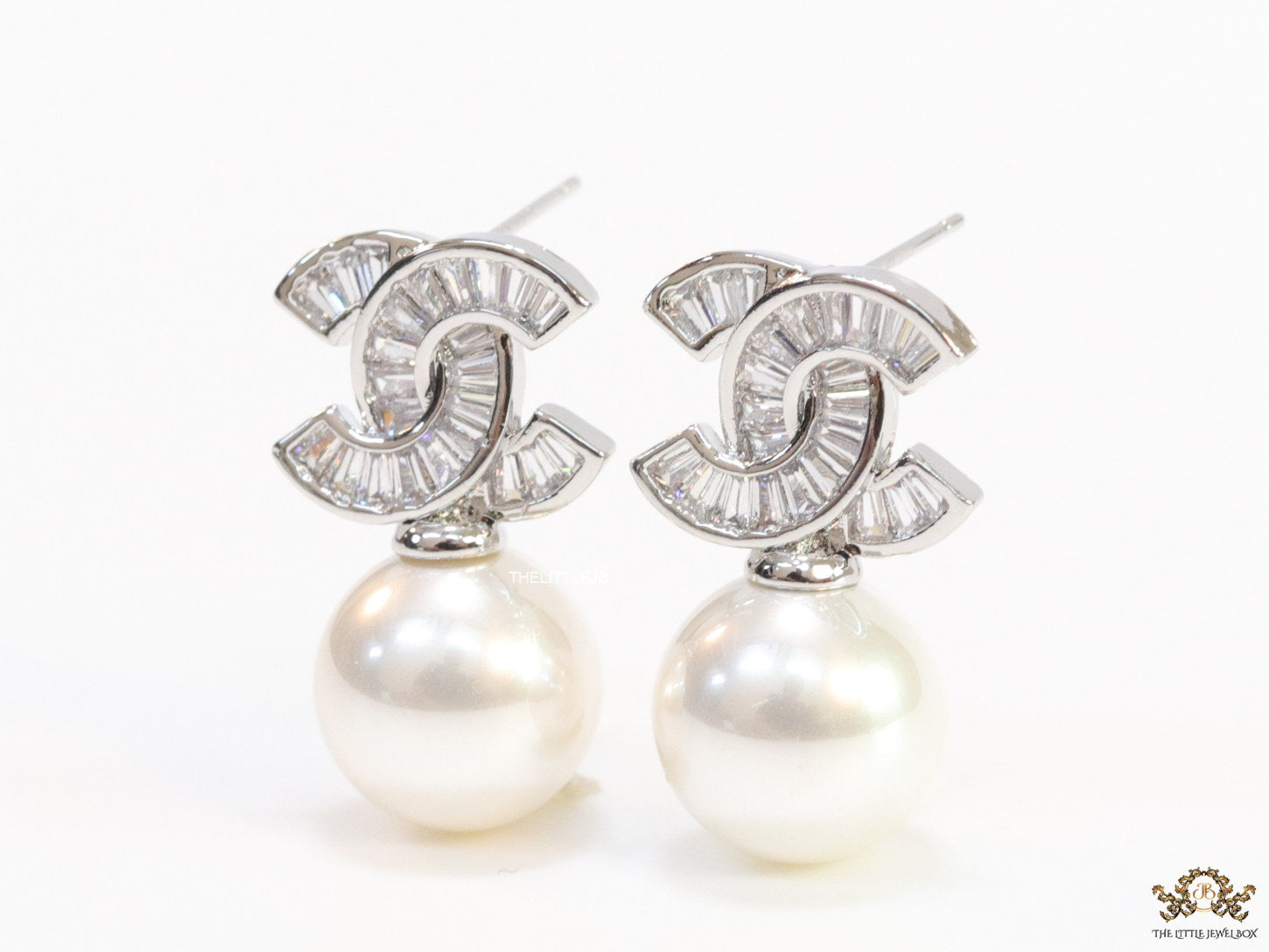 Platinum cz baguettes studded twin C motif stud with pearl drop
