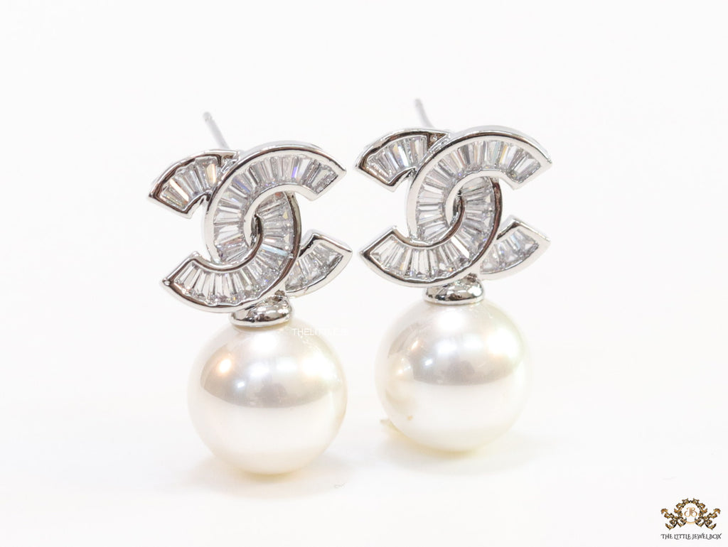 Platinum cz baguettes studded twin C motif stud with pearl drop