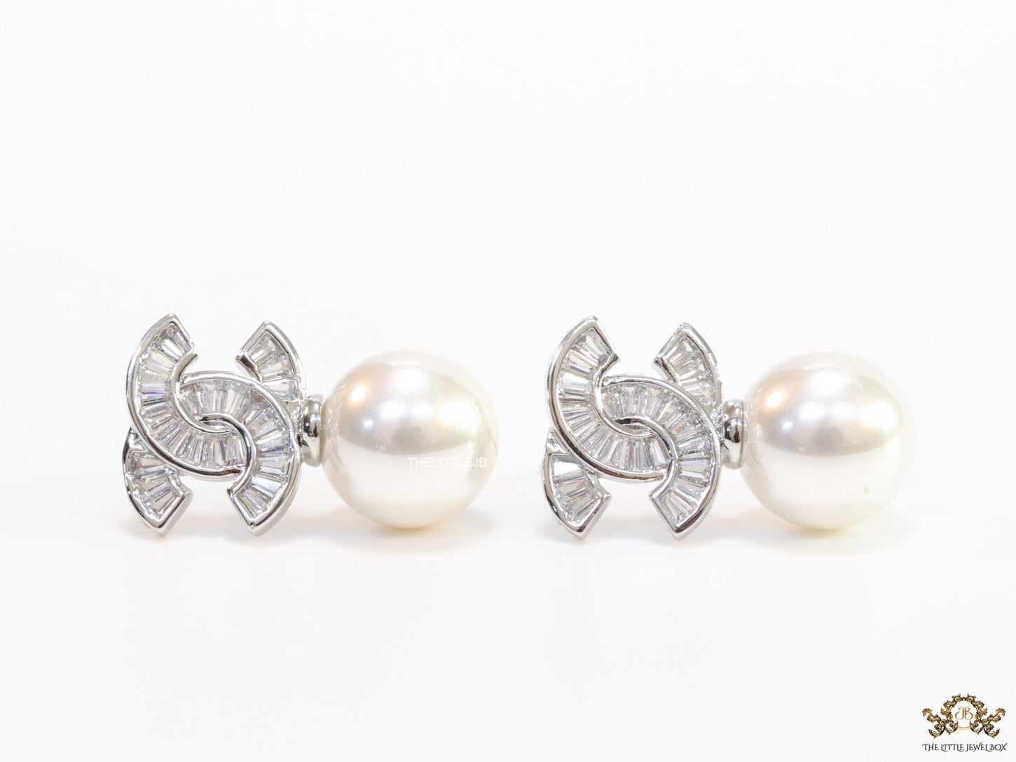 Platinum cz baguettes studded twin C motif stud with pearl drop