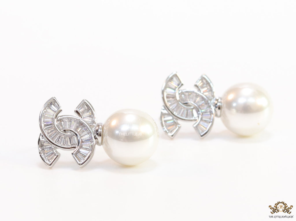 Platinum cz baguettes studded twin C motif stud with pearl drop