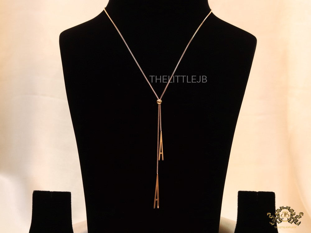 A initial sling necklace in gold finish