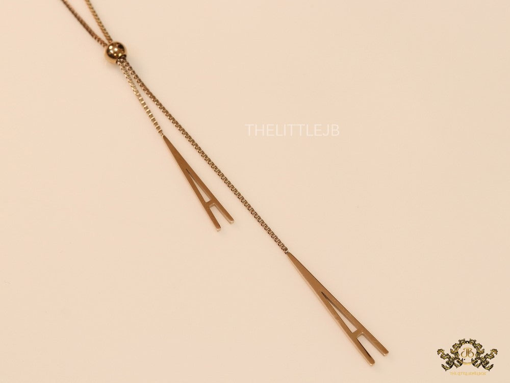 A initial sling necklace in gold finish