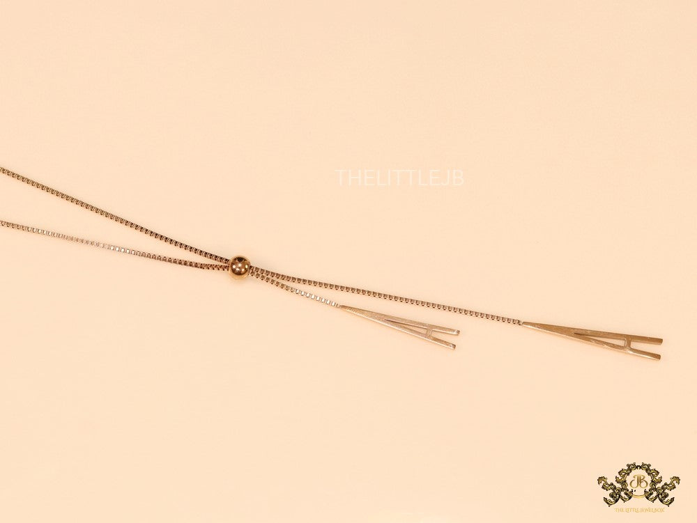A initial sling necklace in gold finish