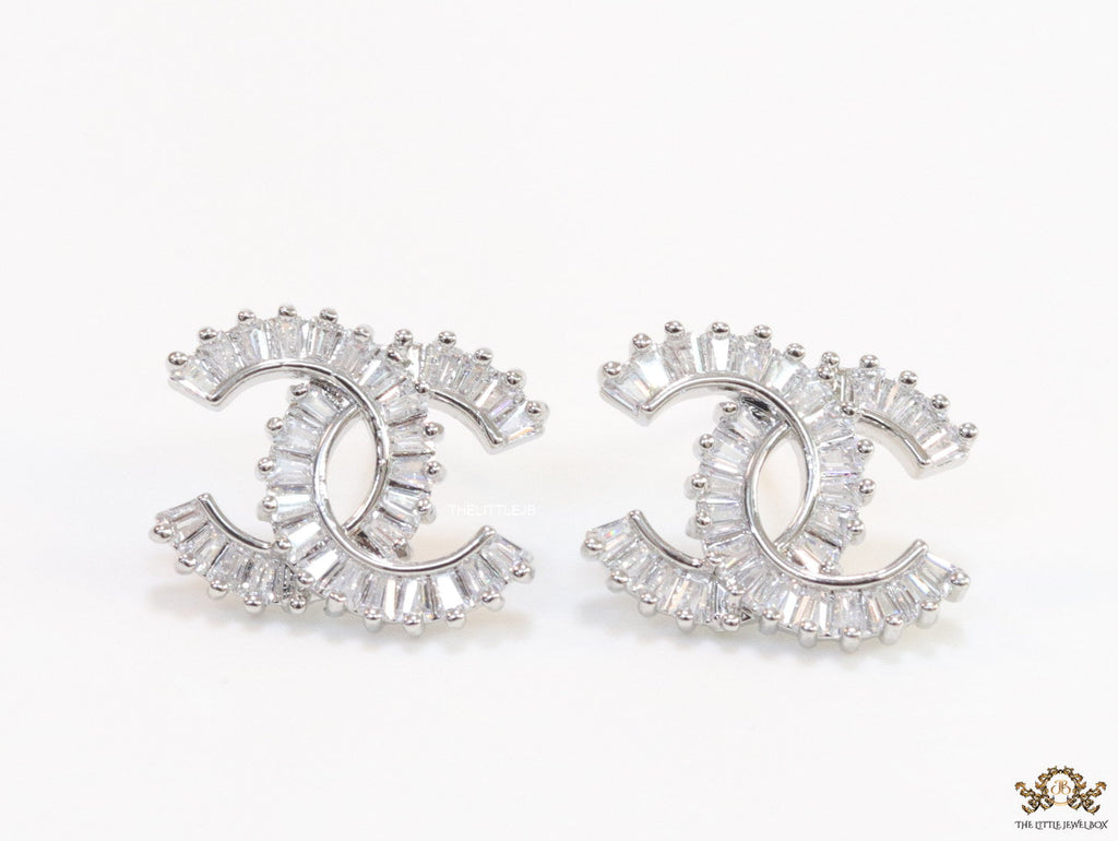 Platinum plated twin C motif studs in cz baguettes