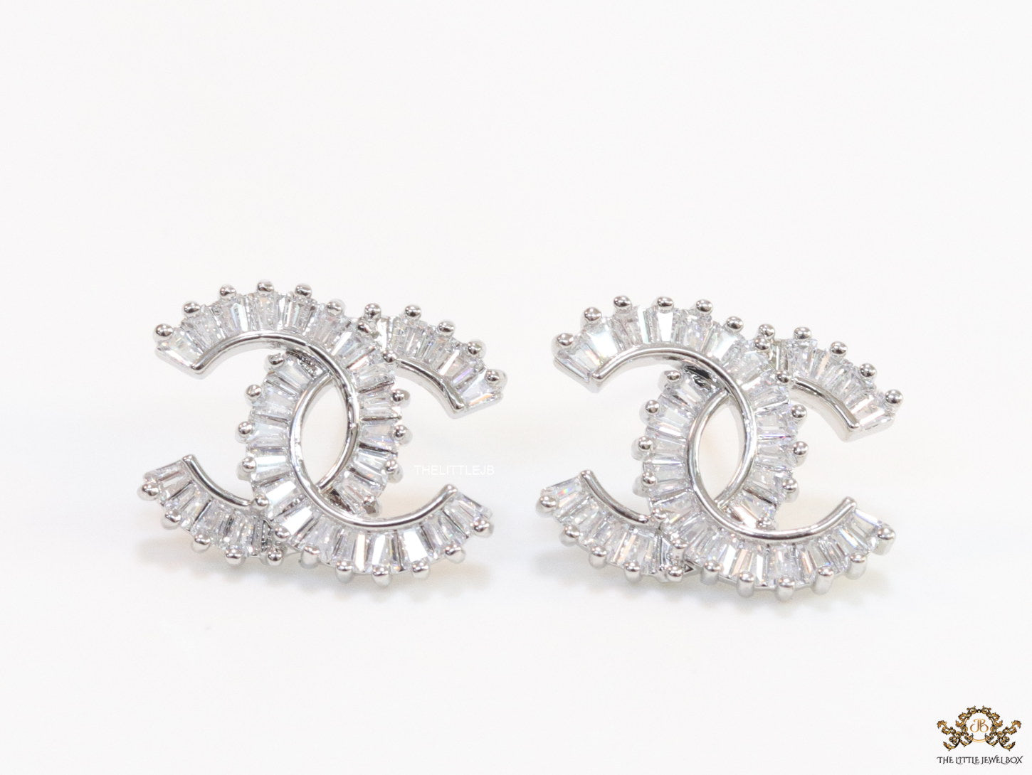 Platinum plated twin C motif studs in cz baguettes