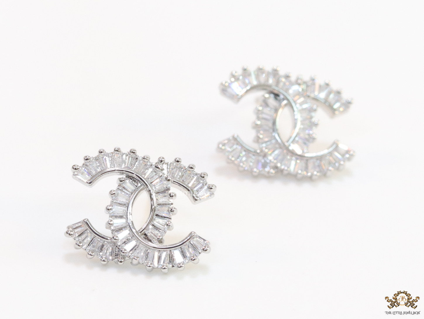 Platinum plated twin C motif studs in cz baguettes