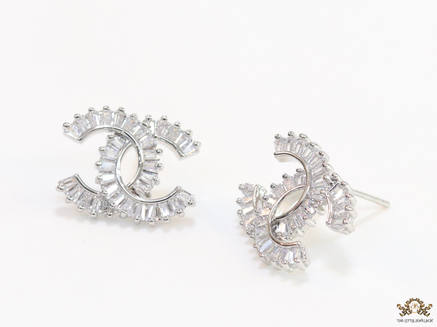 Platinum plated twin C motif studs in cz baguettes
