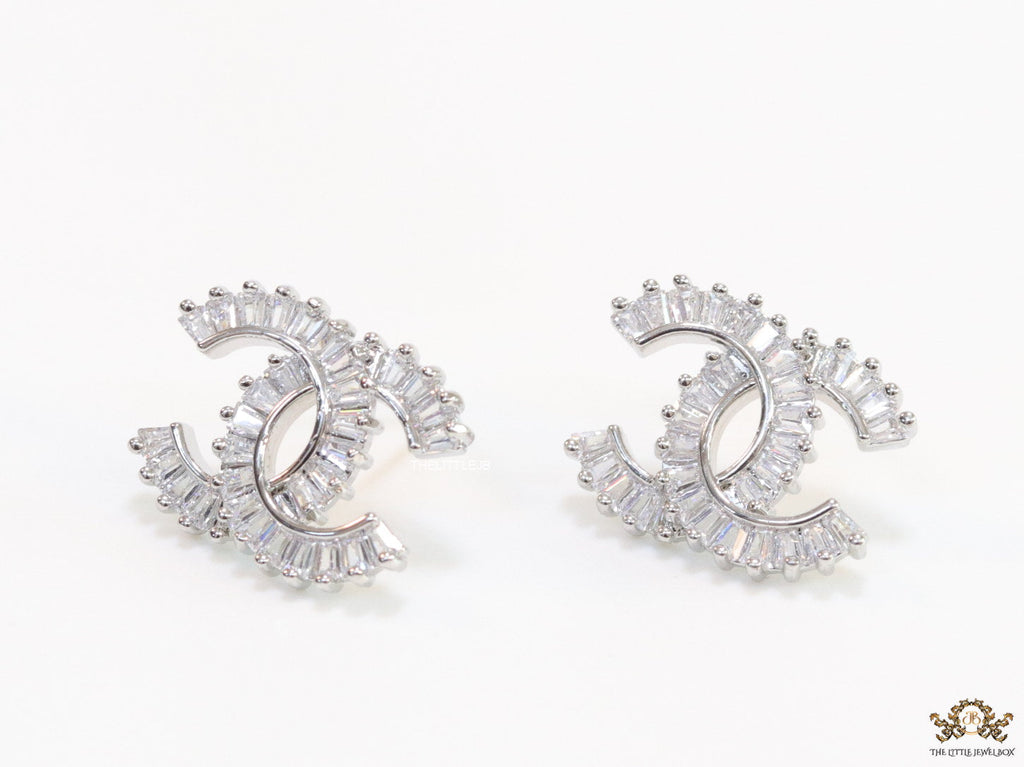 Platinum plated twin C motif studs in cz baguettes