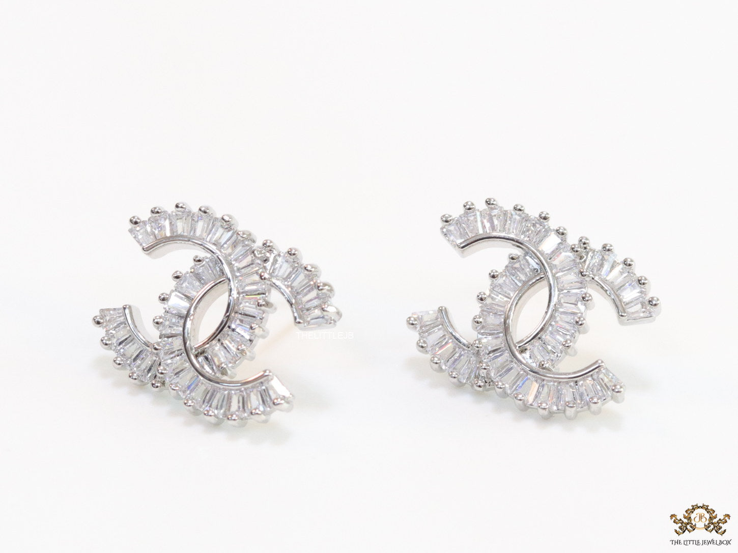 Platinum plated twin C motif studs in cz baguettes