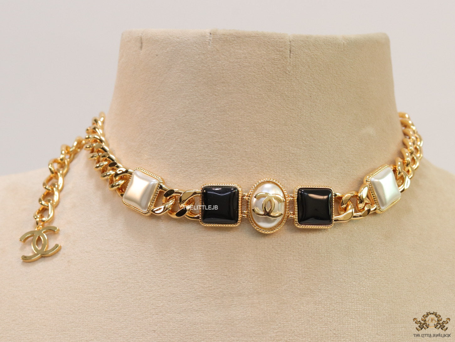 Gold plated link chain choker with MOP and black stone units.