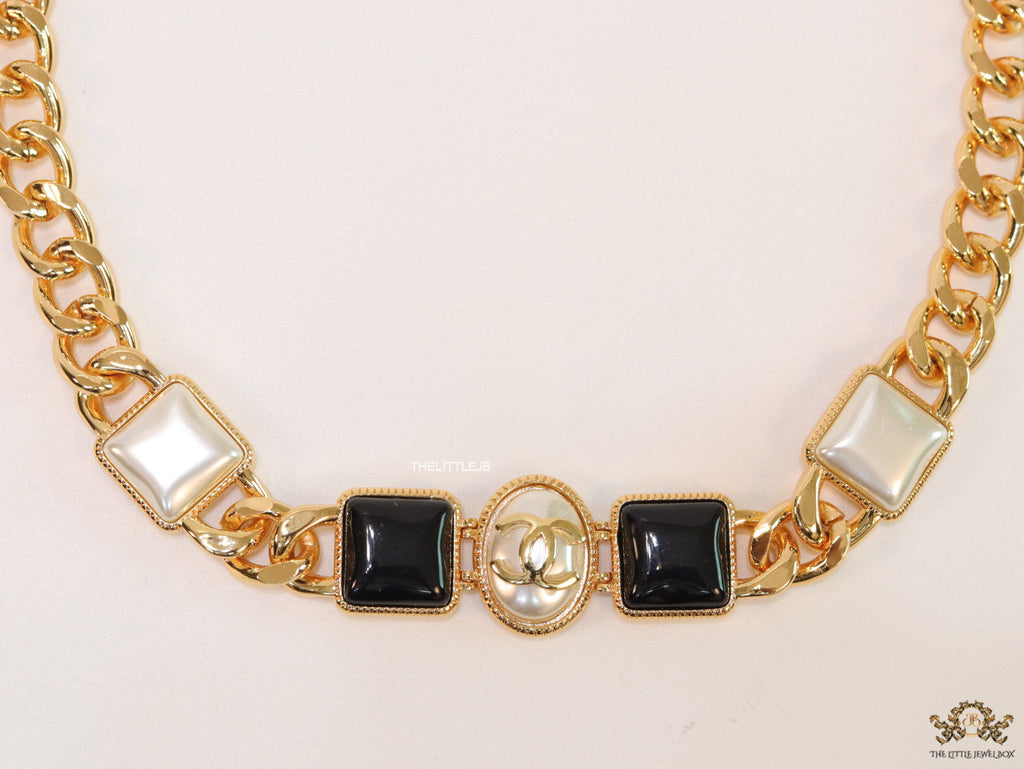 Gold plated link chain choker with MOP and black stone units.