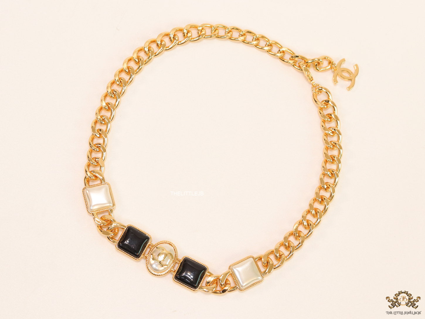 Gold plated link chain choker with MOP and black stone units.