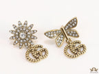 Flower and butterfly cz earrings in antique gold with twin G drops