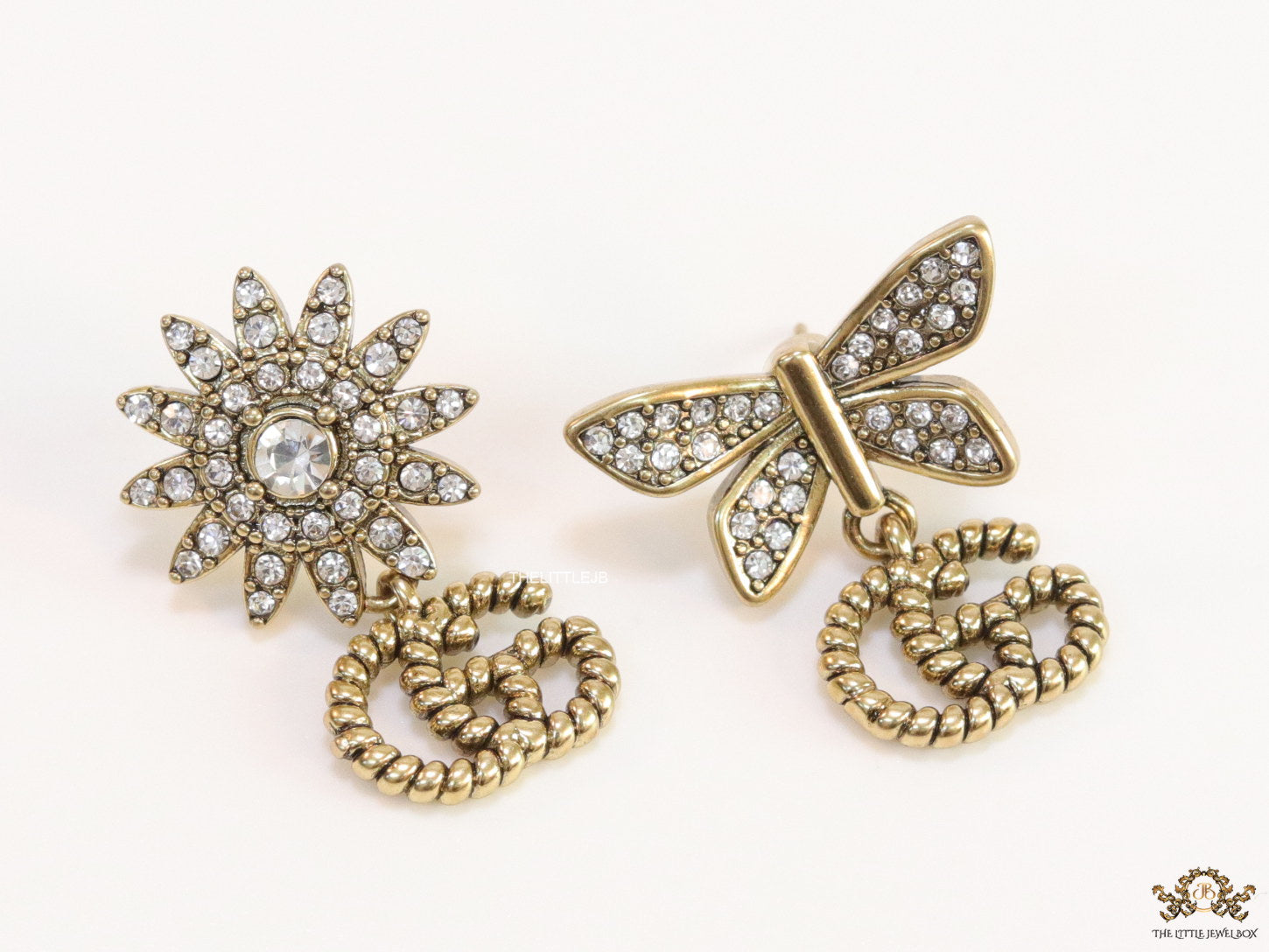 Flower and butterfly cz earrings in antique gold with twin G drops