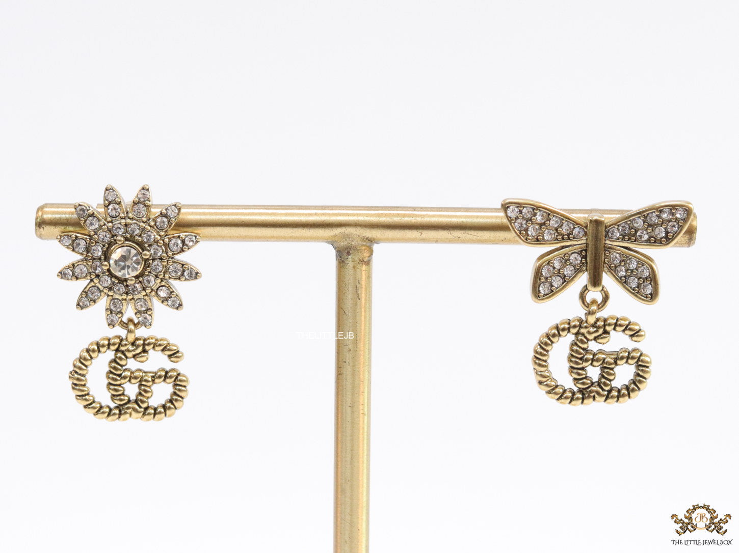 Flower and butterfly cz earrings in antique gold with twin G drops