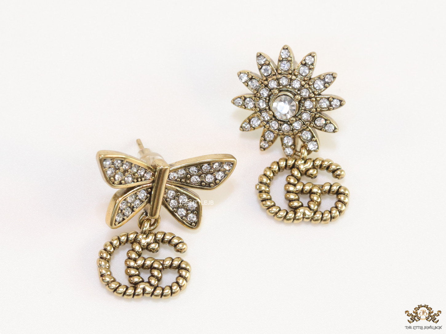 Flower and butterfly cz earrings in antique gold with twin G drops