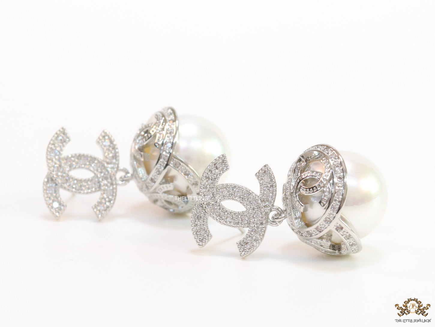 Platinum plated twin C earrings in cz with cz capped pearl drop