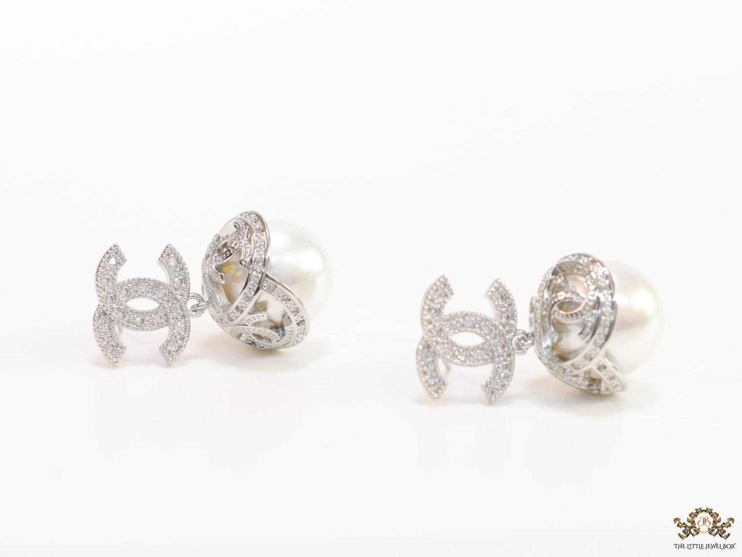 Platinum plated twin C earrings in cz with cz capped pearl drop