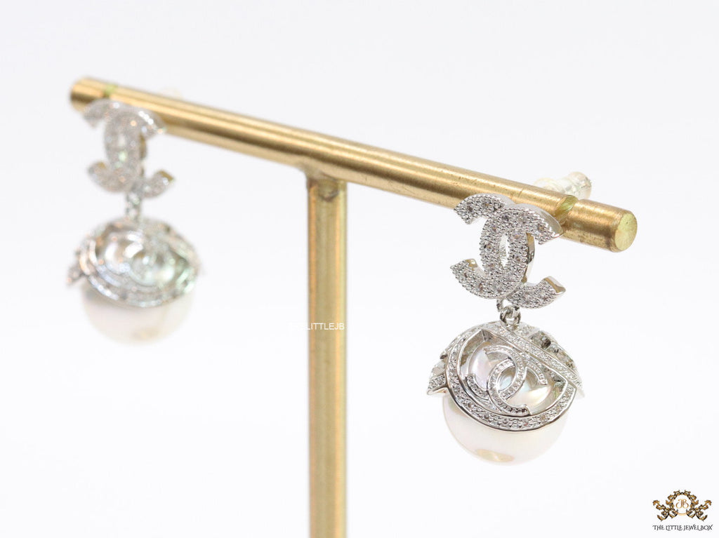 Platinum plated twin C earrings in cz with cz capped pearl drop