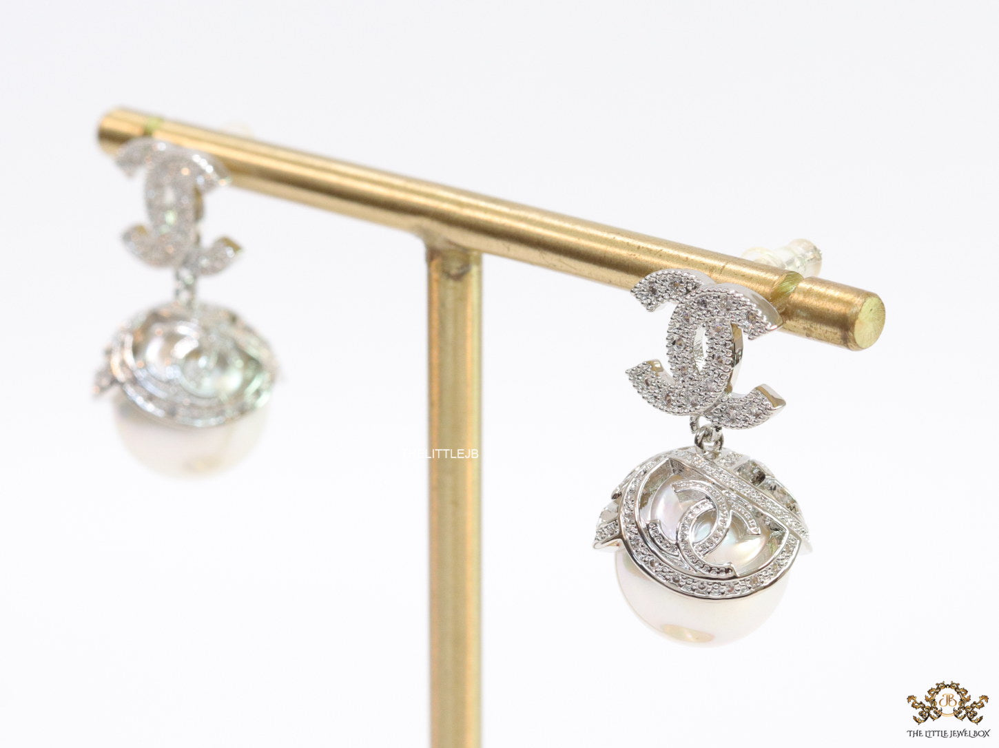 Platinum plated twin C earrings in cz with cz capped pearl drop