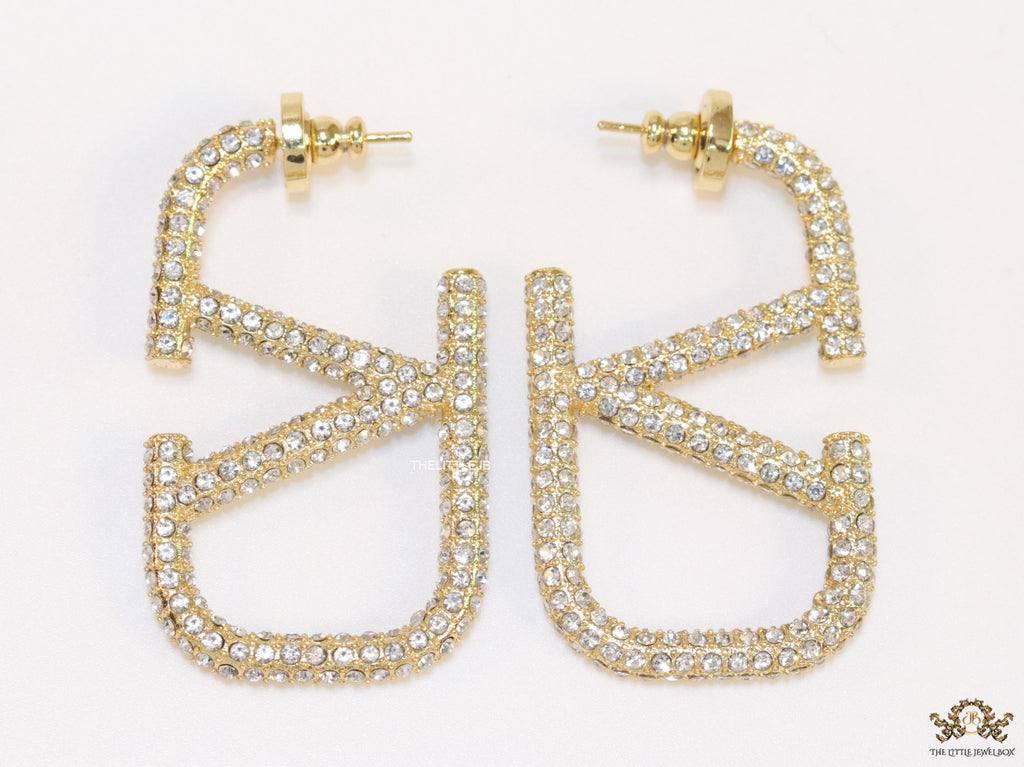 Open golden alphabet earrings with cz