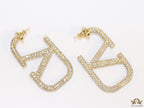 Open golden alphabet earrings with cz