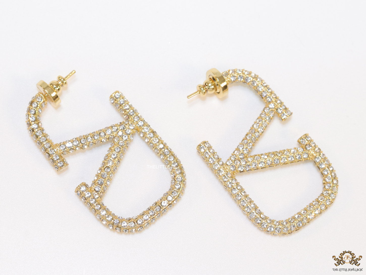 Open golden alphabet earrings with cz