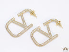 Open golden alphabet earrings with cz