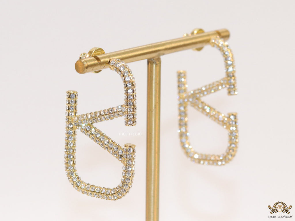 Open golden alphabet earrings with cz