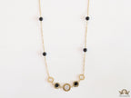 Golden chain necklace with black beads and golden alphabet discs, cz and more