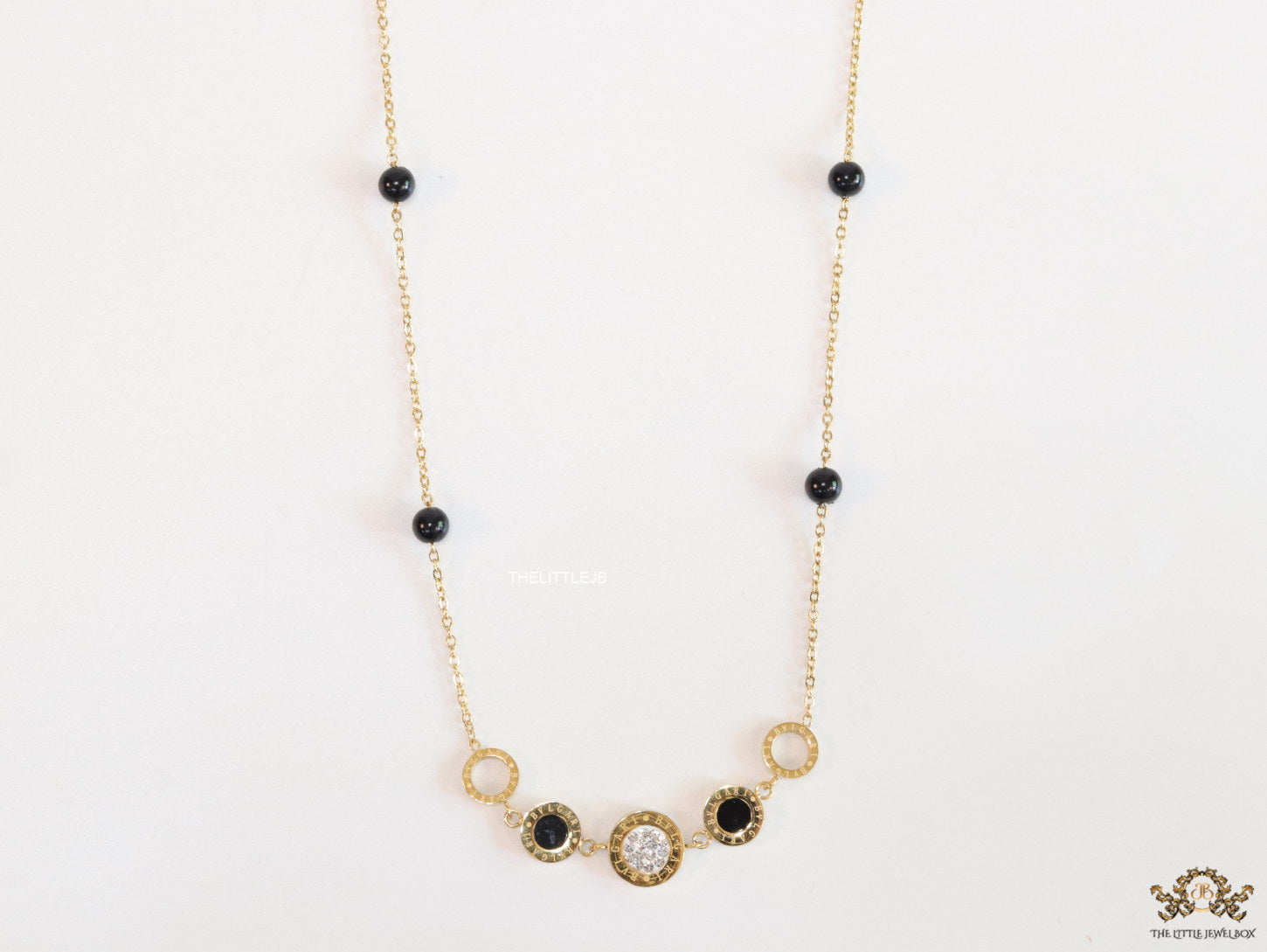 Golden chain necklace with black beads and golden alphabet discs, cz and more