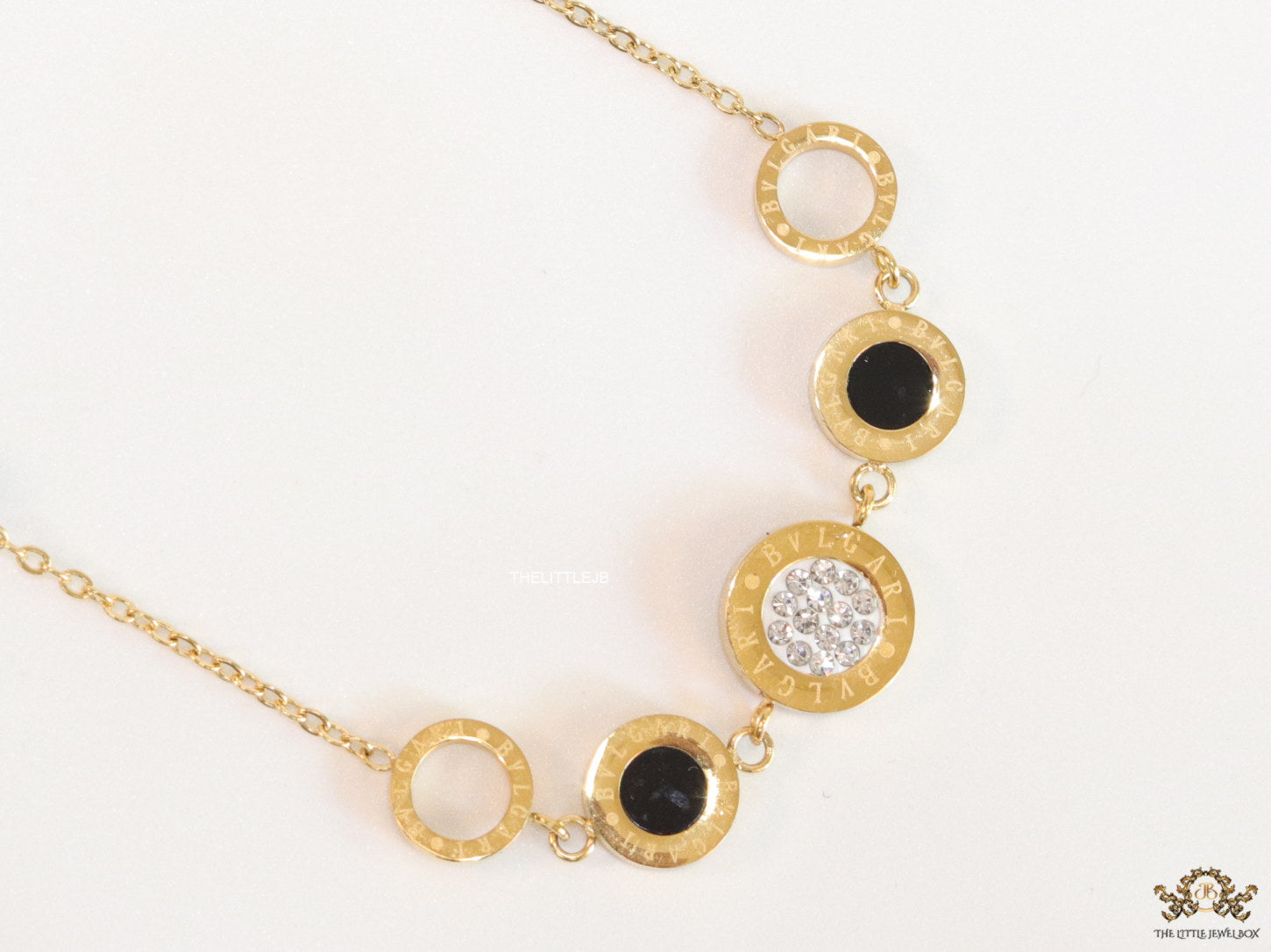 Golden chain necklace with black beads and golden alphabet discs, cz and more
