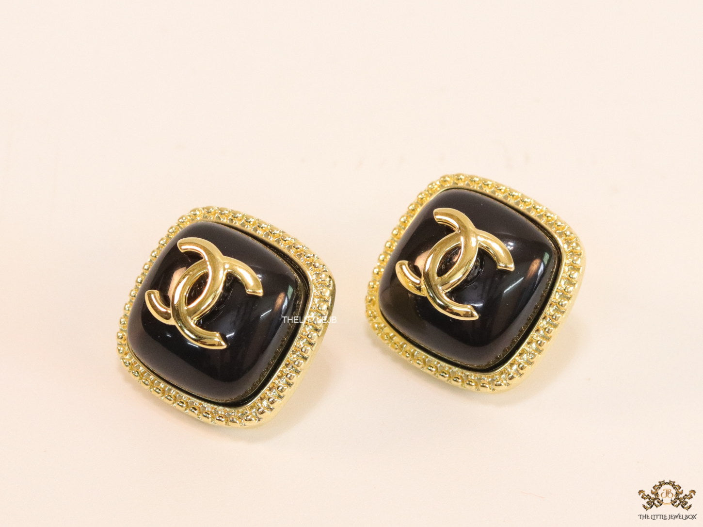 Twin C motif square studs in golden and black finish