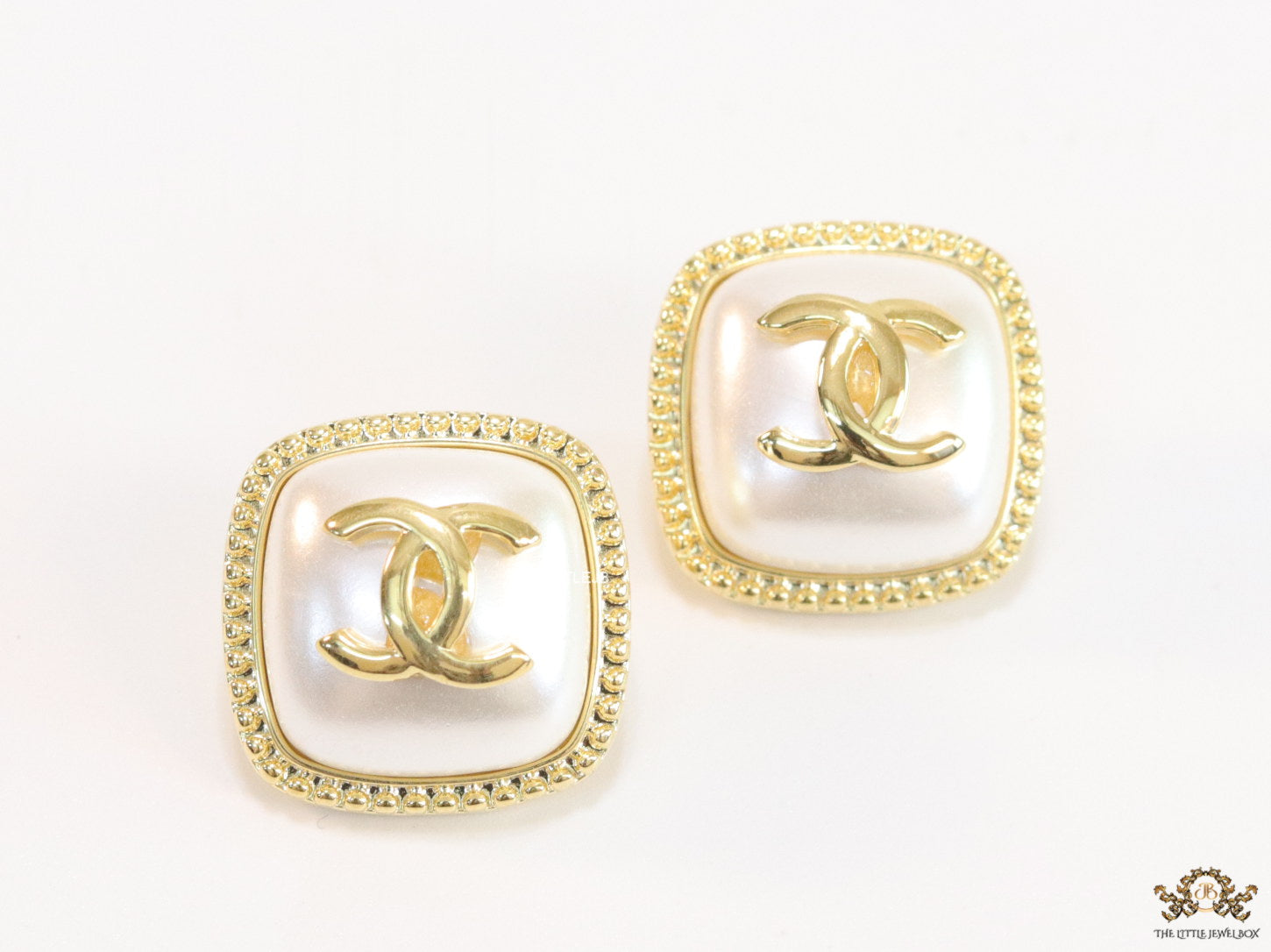 Twin C motif square studs in golden and MOP finish