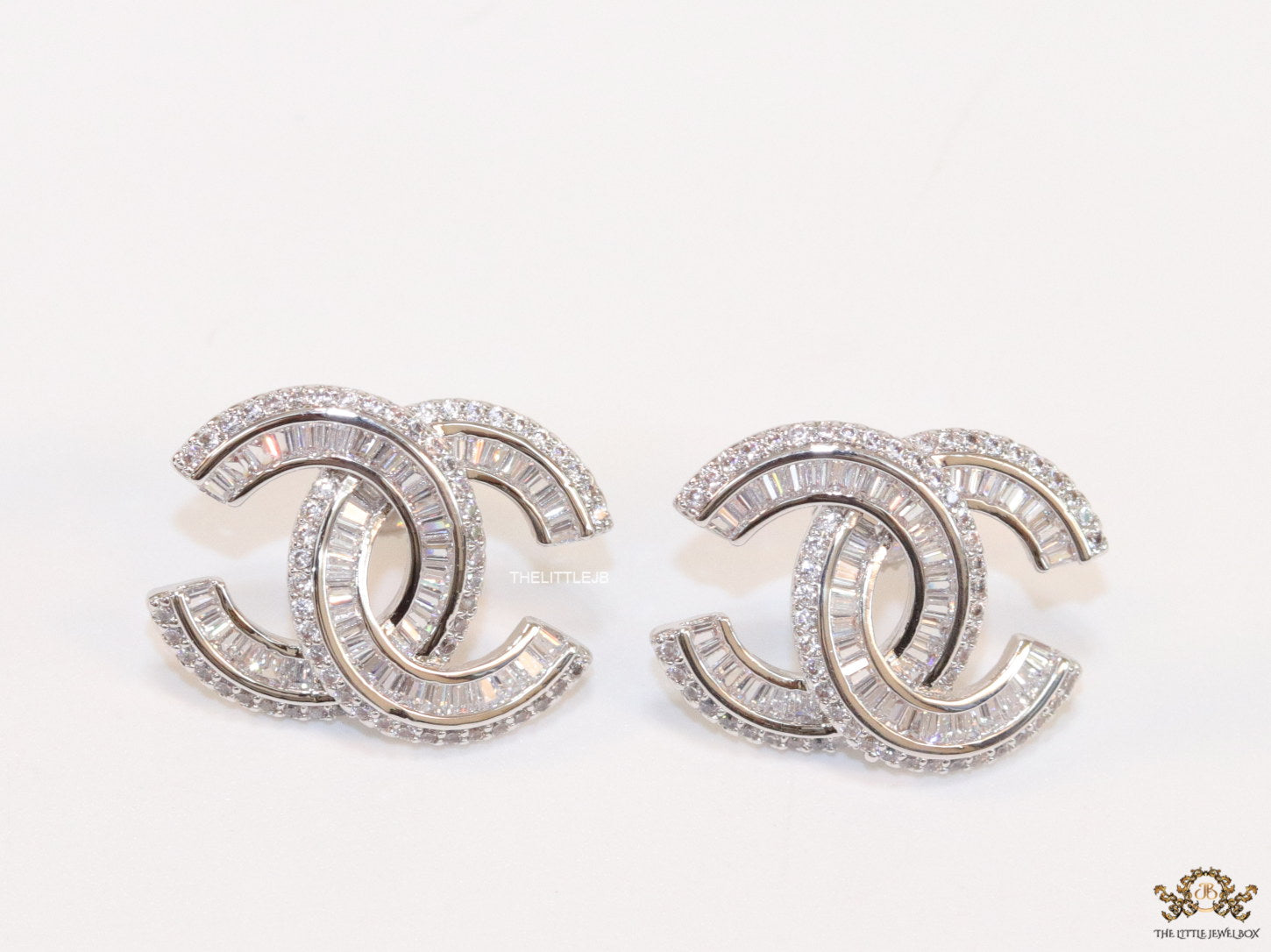 Platinum plated cz studs in twin C motif