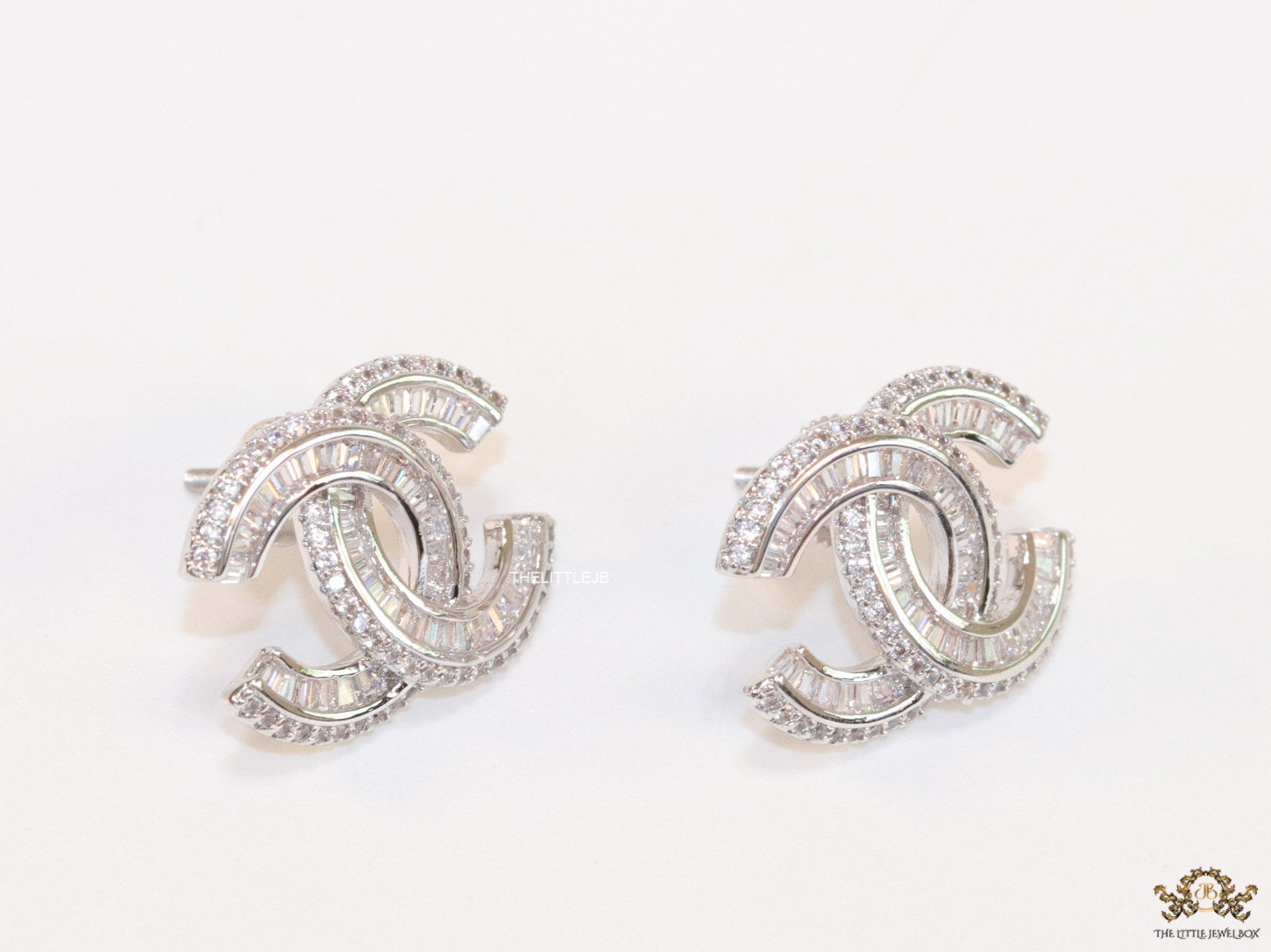 Platinum plated cz studs in twin C motif