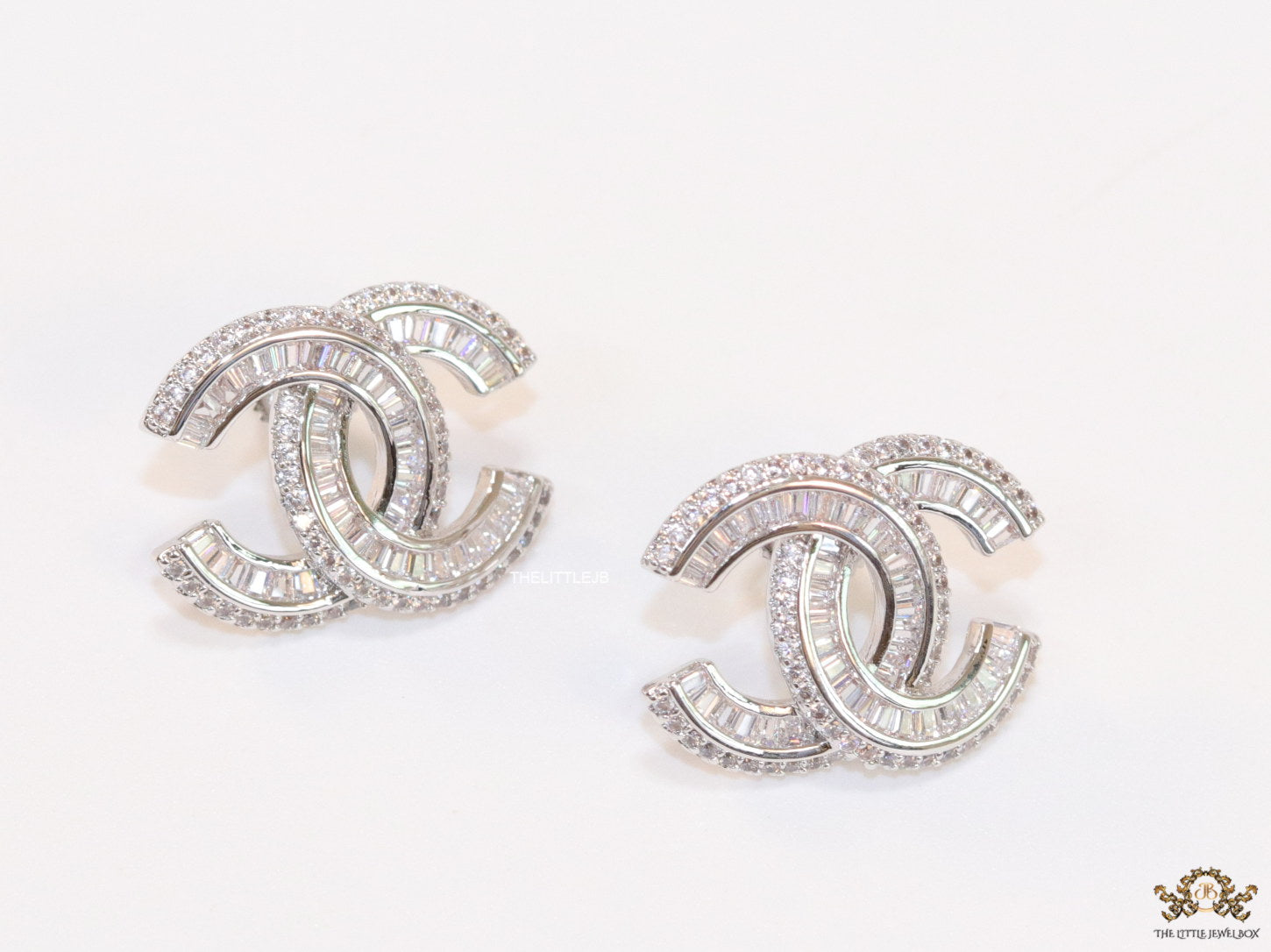 Platinum plated cz studs in twin C motif
