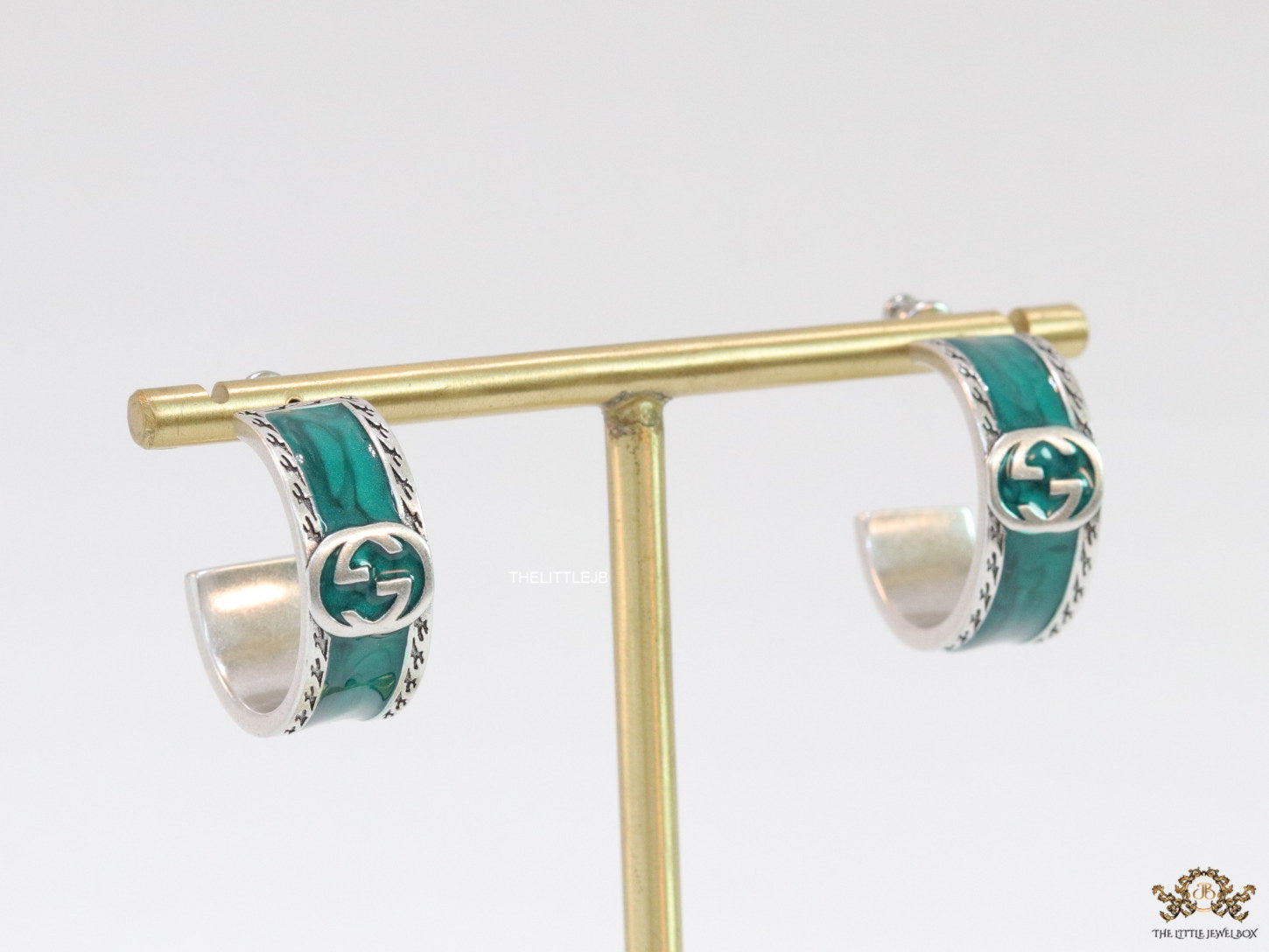 Blue green platinum studs with twin G motif
