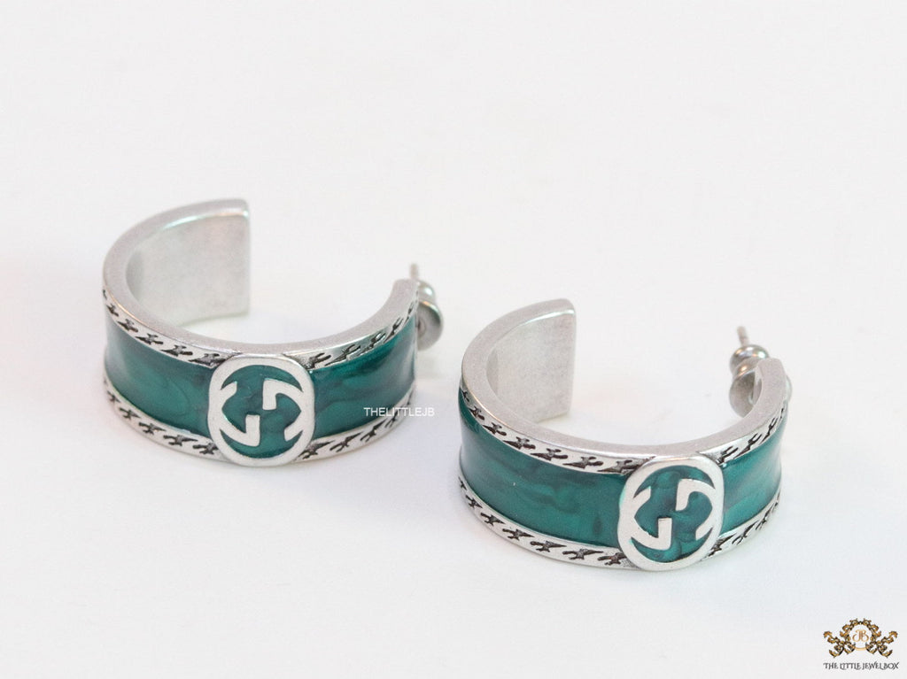 Blue green platinum studs with twin G motif