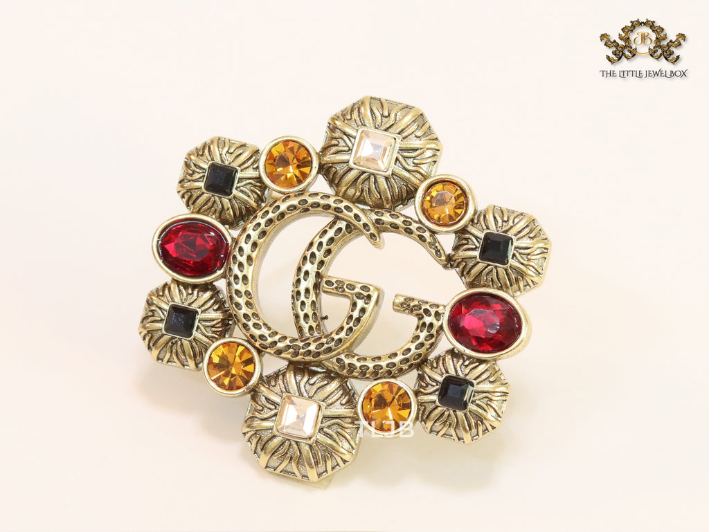 Double G embossed rustic brooch with multi coloured stones