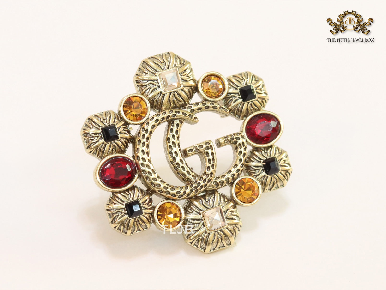 Double G embossed rustic brooch with multi coloured stones