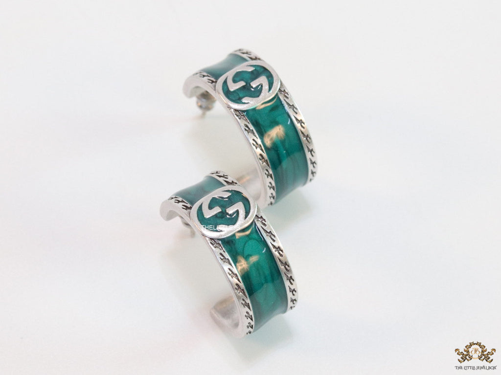 Blue green platinum studs with twin G motif