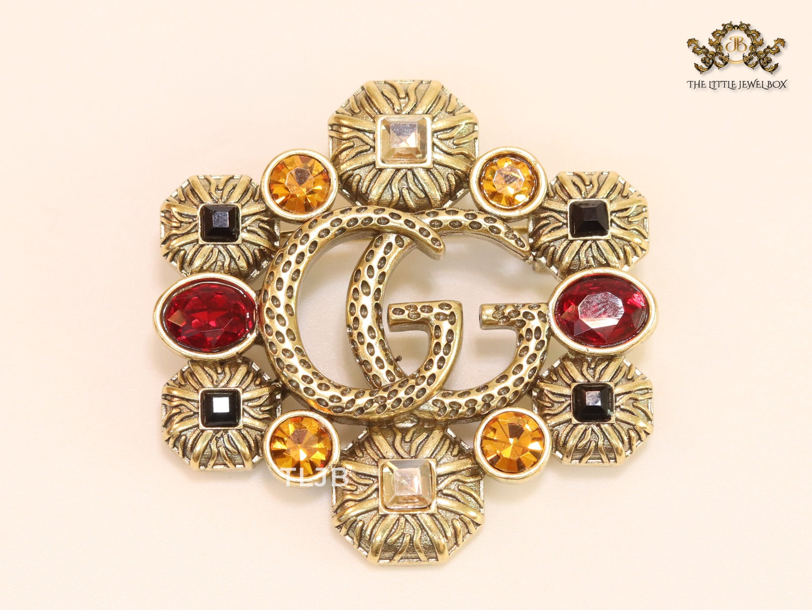 Double G embossed rustic brooch with multi coloured stones