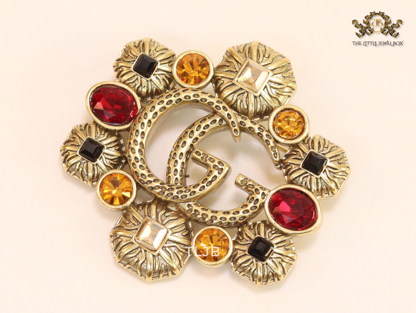 Double G embossed rustic brooch with multi coloured stones