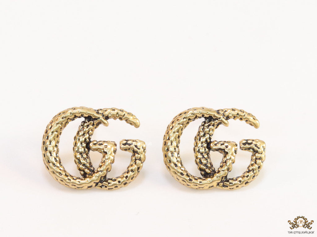 Double G motif studs with woven basket texture in antique gold finish