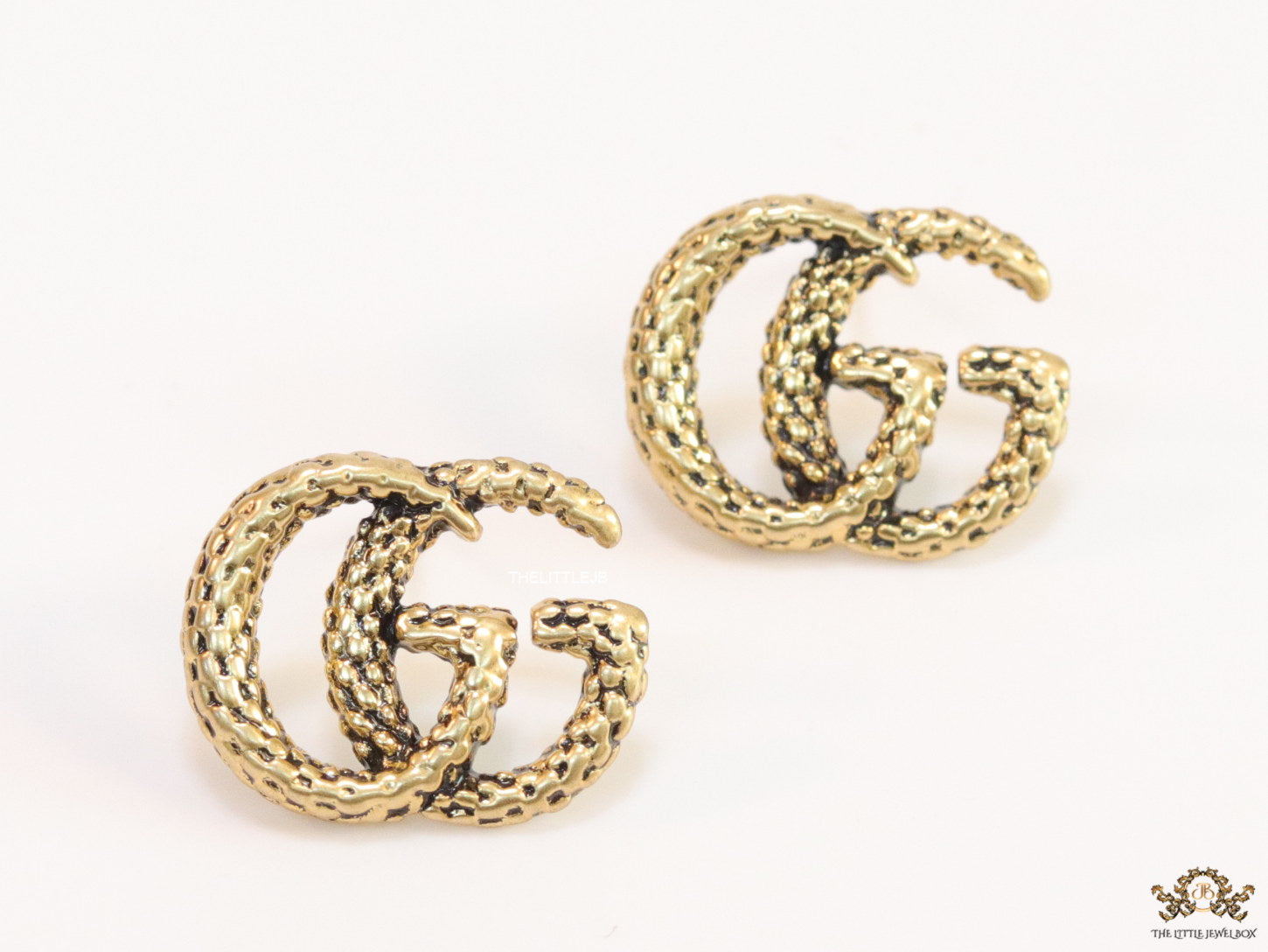 Double G motif studs with woven basket texture in antique gold finish