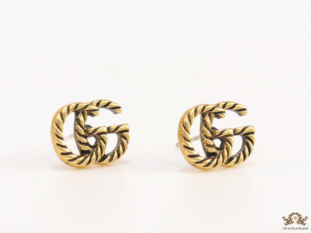 Double G motif studs with rope texture in antique gold finish