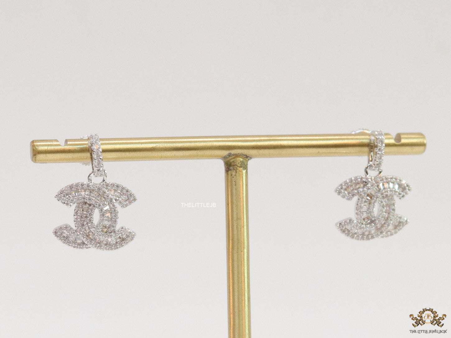 Platinum plated cz dangle earrings with twin C motif