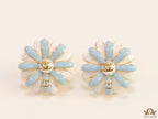 Off-white and soft blue daisy studs with golden details twin alphabet double C motif.