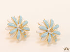 Off-white and soft blue daisy studs with golden details twin alphabet double C motif.